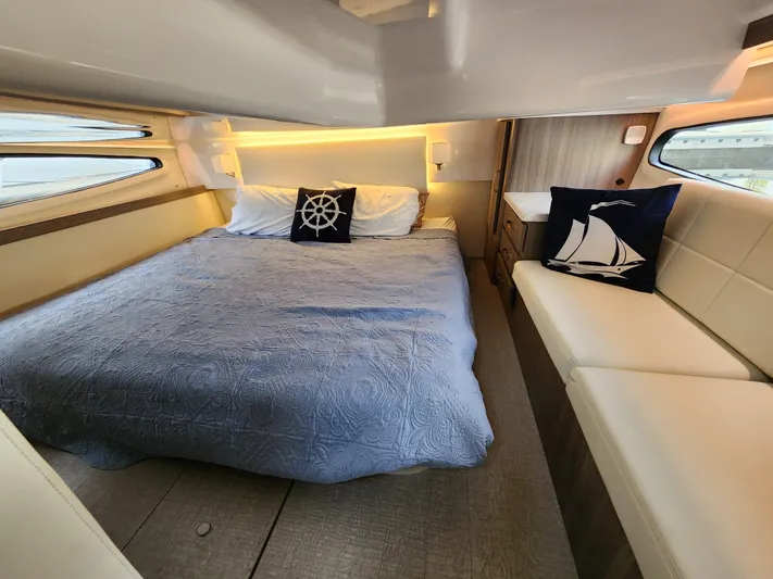 Foxyot Yacht Photos Pics Luxurious cabin interior of 2022 Regal 38 Grande Coupe yacht with nautical decor.