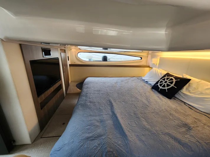 Foxyot Yacht Photos Pics Luxurious cabin interior of 2022 Regal 38 Grande Coupe yacht with cozy bedding.