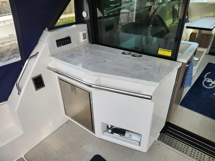 Foxyot Yacht Photos Pics 2022 Regal 38 Grande Coupe yacht interior with sleek kitchenette and modern design.