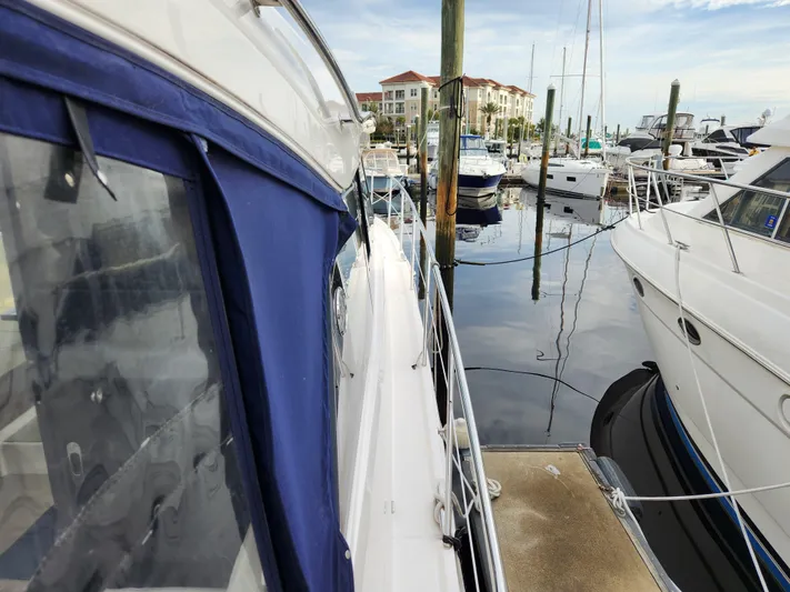 Foxyot Yacht Photos Pics 2022 Regal 38 Grande Coupe docked at marina with other boats.