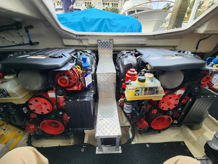 Foxyot Yacht Photos Pics Engine compartment of 2022 Regal 38 Grande Coupe with dual engines and red accents.