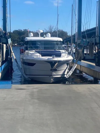 Foxyot Yacht Photos Pics 2022 Regal 38 Grande Coupe docked at marina under clear sky.