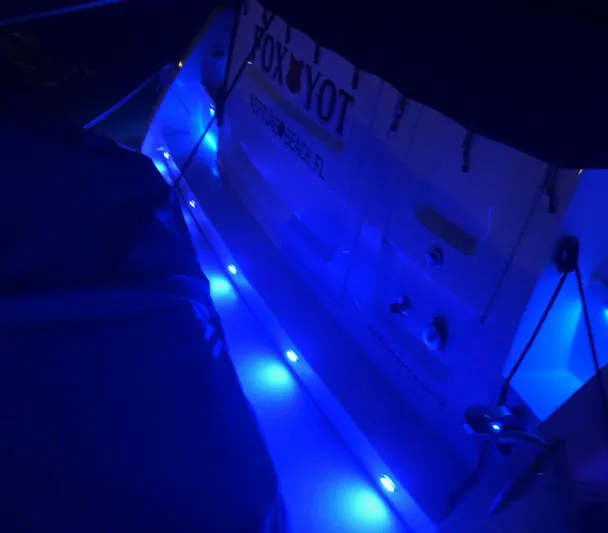 Foxyot Yacht Photos Pics 2022 Regal 38 Grande Coupe with blue LED lights at night.