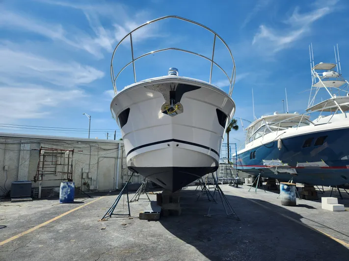 Foxyot Yacht Photos Pics 2022 Regal 38 Grande Coupe yacht on dry dock under clear blue sky.