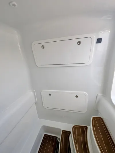  Yacht Photos Pics 2020 Yellowfin 39 Offshore interior with storage compartments and wooden steps.