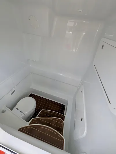  Yacht Photos Pics 2020 Yellowfin 39 Offshore boat interior with toilet and wooden flooring.