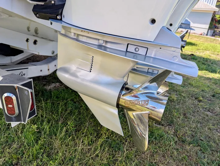  Yacht Photos Pics Propeller of a 2020 Yellowfin 39 Offshore boat on a trailer, parked on grass.