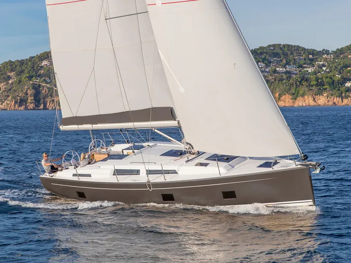 Hanse 418 #303 San Yacht Photos Pics 2023 Hanse 418 sailboat cruising on open water, scenic coastal background.