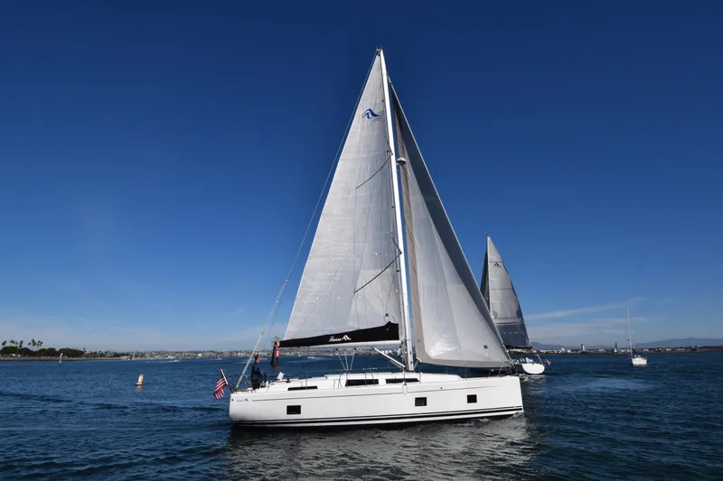 Hanse 418 #303 San Yacht Photos Pics 2023 Hanse 418 sailboat navigating calm waters under clear blue skies.