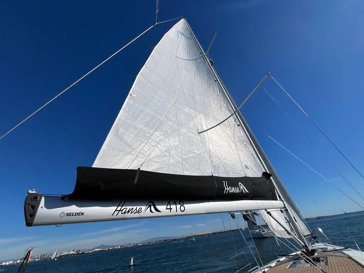 Hanse 418 #303 San Yacht Photos Pics Sailing yacht Hanse 418, 2023 model, with sails unfurled on open water.