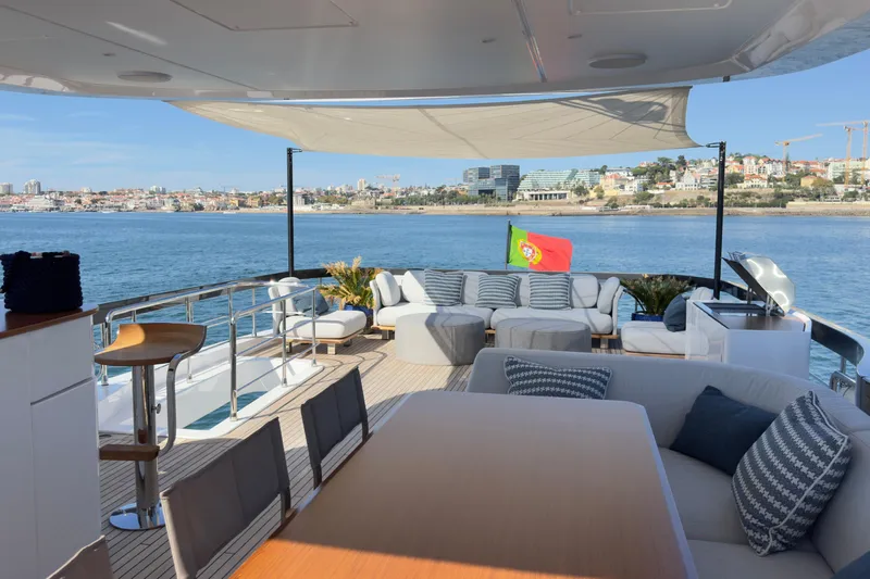  Yacht Photos Pics Luxurious 2025 Azimut Grande 26M yacht deck with seating, ocean view, and Portuguese flag.