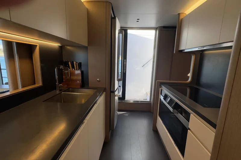  Yacht Photos Pics Modern kitchen interior of 2025 Azimut Grande 26M yacht, featuring sleek cabinetry and appliances.