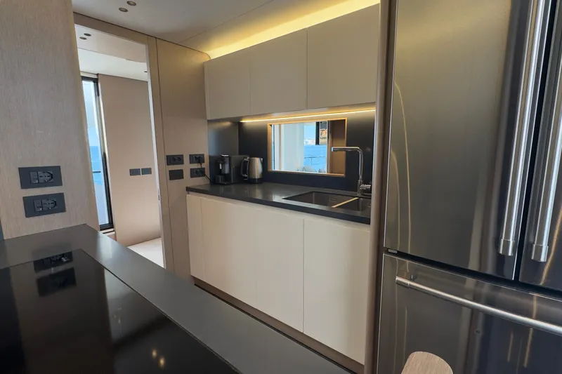  Yacht Photos Pics Modern kitchen interior on 2025 Azimut Grande 26M yacht, featuring sleek cabinetry and stainless steel appliances.