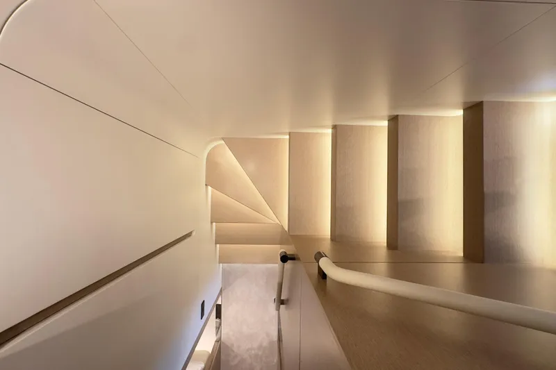  Yacht Photos Pics Modern staircase design inside 2025 Azimut Grande 26M yacht, featuring elegant lighting and sleek lines.