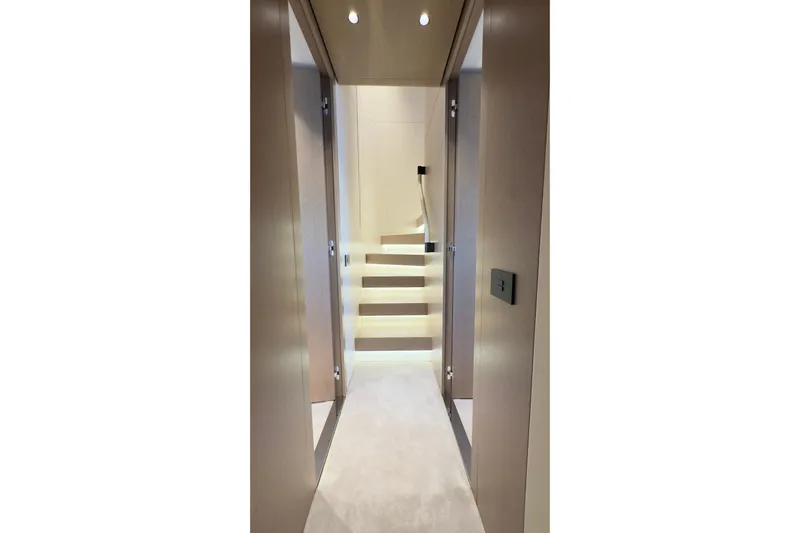  Yacht Photos Pics Luxurious interior hallway of 2025 Azimut Grande 26M yacht with modern staircase.