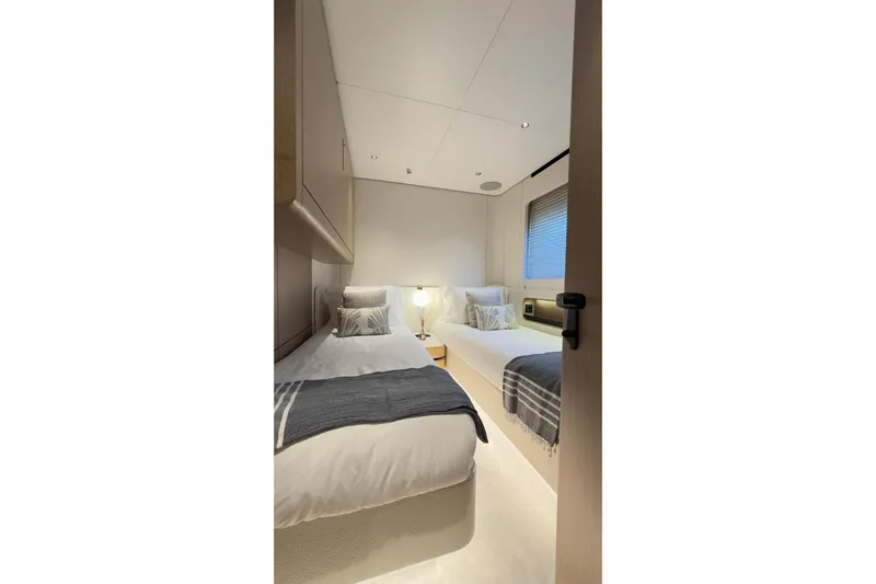  Yacht Photos Pics Luxurious twin bedroom in 2025 Azimut Grande 26M yacht, featuring modern decor and cozy ambiance.