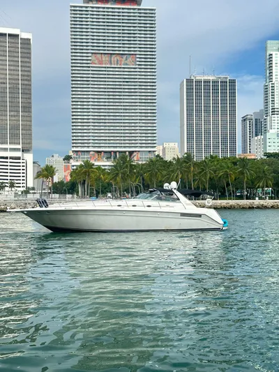  Yacht Photos Pics 1994 Sea Ray 500 Sundancer yacht on urban waterfront with skyscrapers.