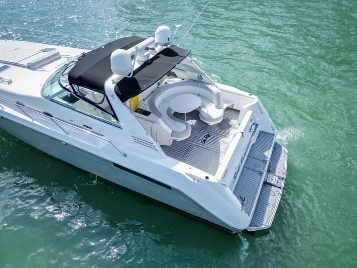  Yacht Photos Pics 1994 Sea Ray 500 Sundancer yacht on clear water, featuring spacious deck and seating area.