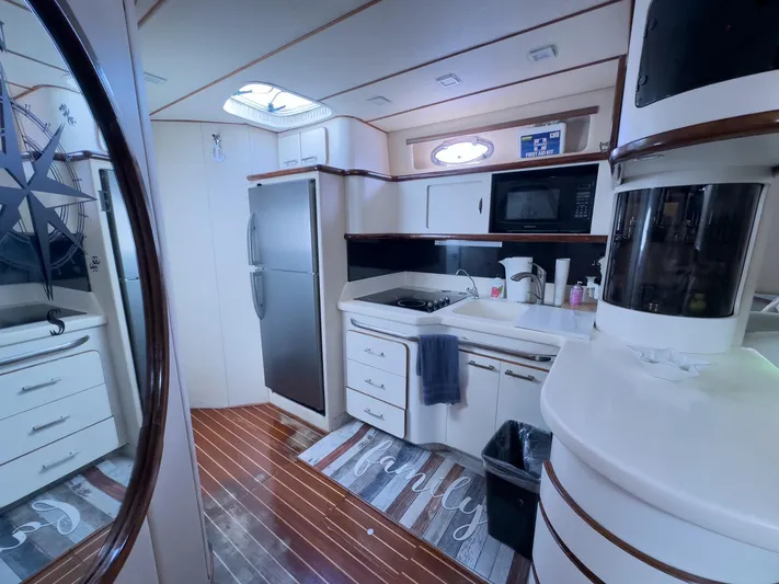  Yacht Photos Pics Interior of 1994 Sea Ray 500 Sundancer yacht kitchen with modern appliances and wood flooring.