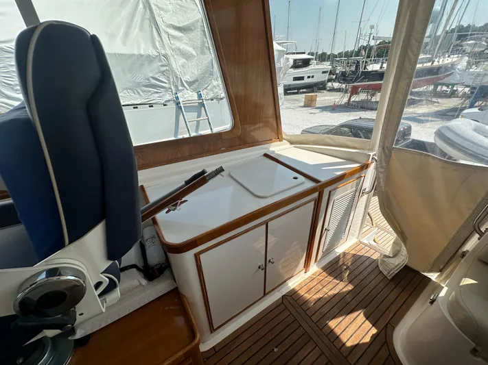 Vivacious Yacht Photos Pics Interior of 2002 Grand Banks Eastbay 43 yacht with wooden flooring and seating.