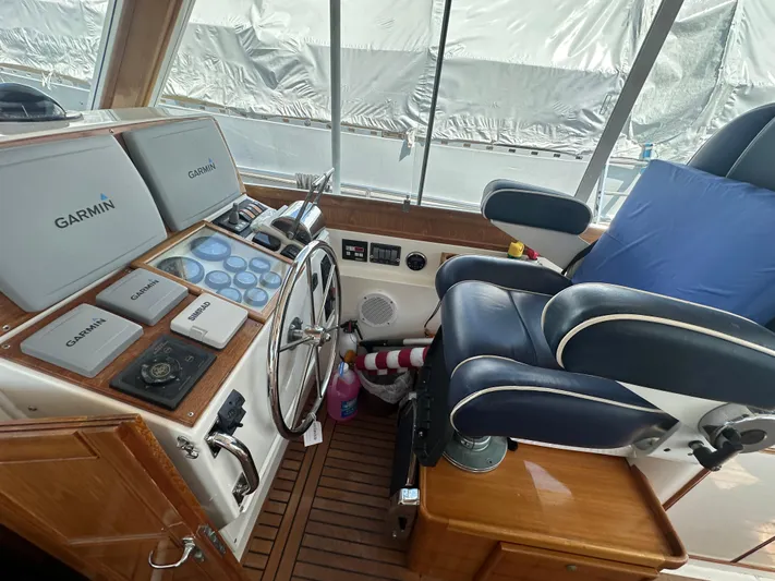Vivacious Yacht Photos Pics Helm of 2002 Grand Banks Eastbay 43 with Garmin navigation equipment and captain's chair.