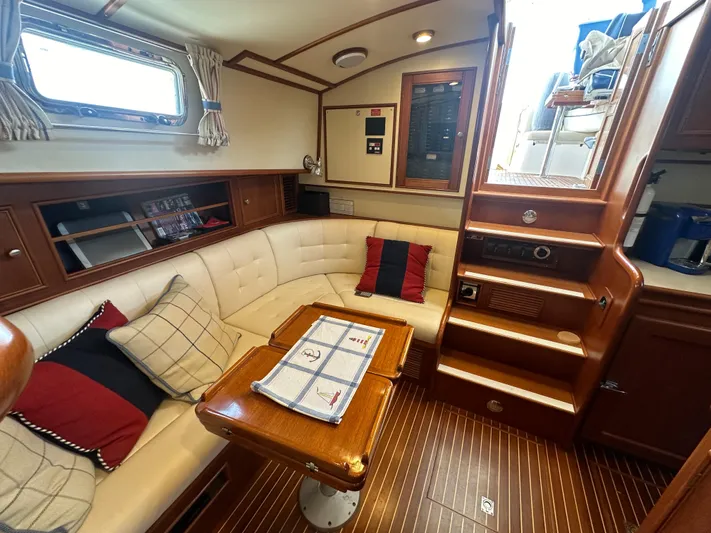 Vivacious Yacht Photos Pics Luxurious 2002 Grand Banks Eastbay 43 yacht interior with cozy seating and elegant wood finishes.