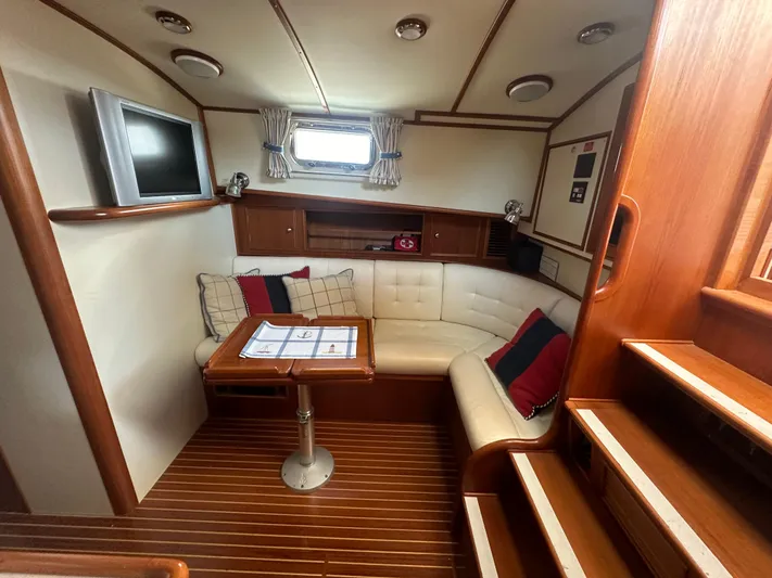 Vivacious Yacht Photos Pics Luxurious 2002 Grand Banks Eastbay 43 yacht interior with cozy seating and elegant wood finish.