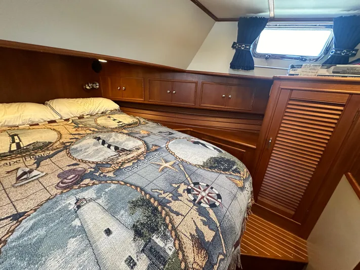 Vivacious Yacht Photos Pics Cozy cabin interior of 2002 Grand Banks Eastbay 43 with nautical-themed bedding.