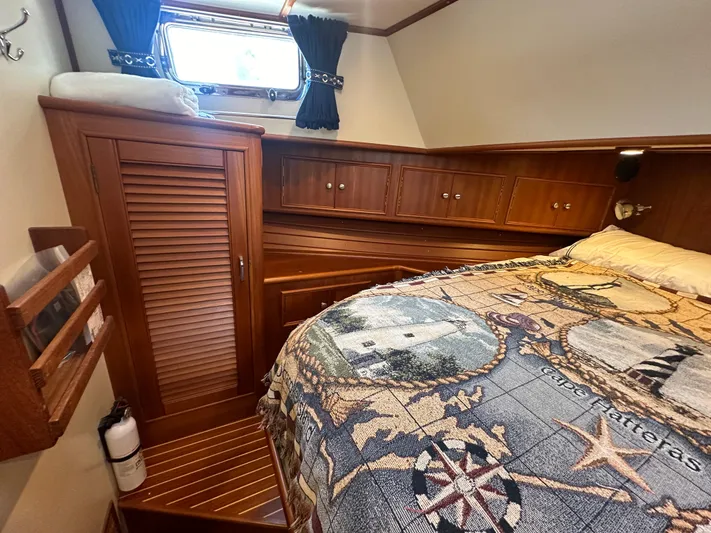 Vivacious Yacht Photos Pics Cozy cabin interior of 2002 Grand Banks Eastbay 43 with nautical-themed bedding.