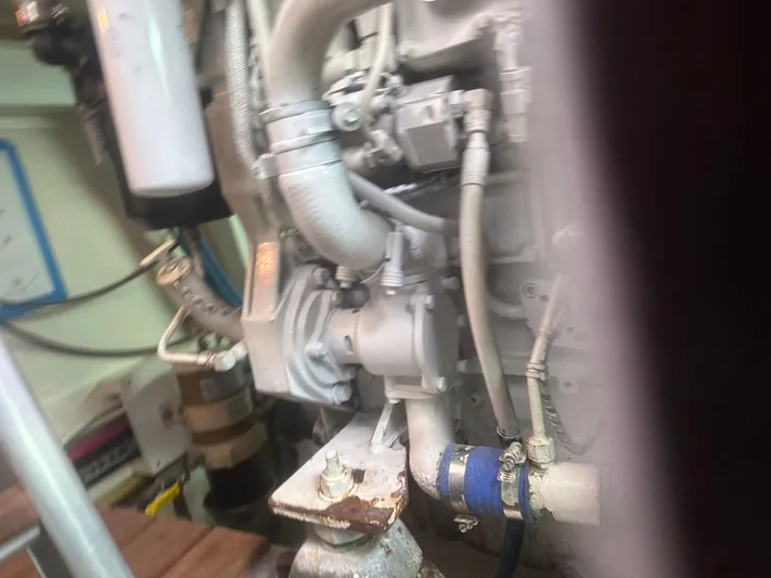 Vivacious Yacht Photos Pics Engine compartment of a 2002 Grand Banks Eastbay 43 yacht, showing mechanical components and hoses.