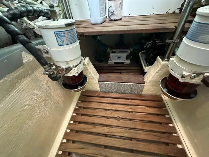Vivacious Yacht Photos Pics Engine room of 2002 Grand Banks Eastbay 43 with Racor fuel filters and wooden flooring.