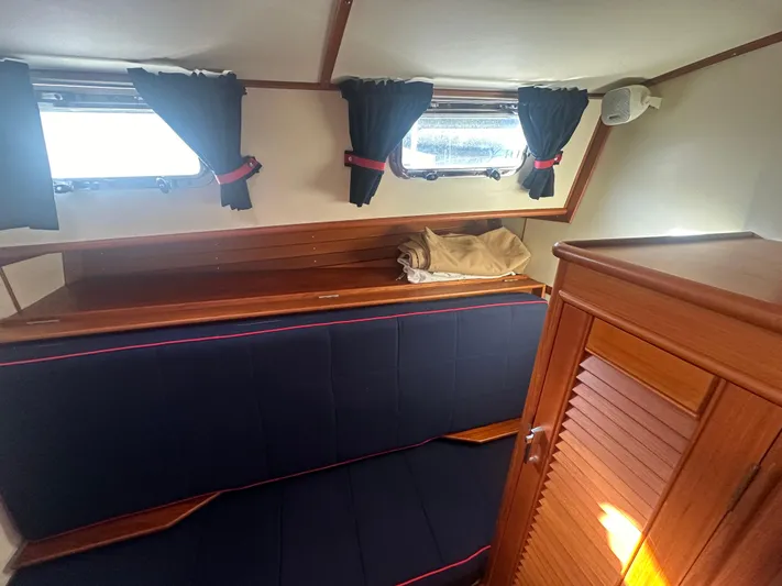 Vivacious Yacht Photos Pics Interior cabin of 2002 Grand Banks Eastbay 43 with blue seating and wooden cabinetry.