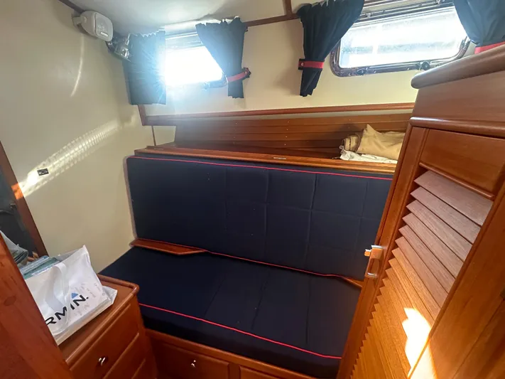 Vivacious Yacht Photos Pics Cozy cabin interior of 2002 Grand Banks Eastbay 43 with navy seating and wooden accents.