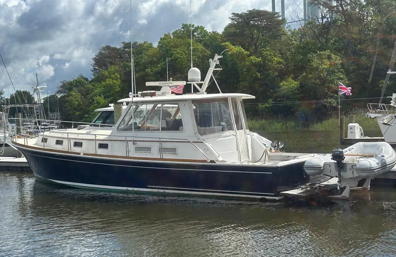 Vivacious Yacht Photos Pics 2002 Grand Banks Eastbay 43 yacht docked, featuring a sleek design and classic styling.