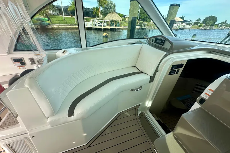  Yacht Photos Pics Interior of 2011 Cruisers Yachts 420 Sports Coupe with white seating and waterfront view.