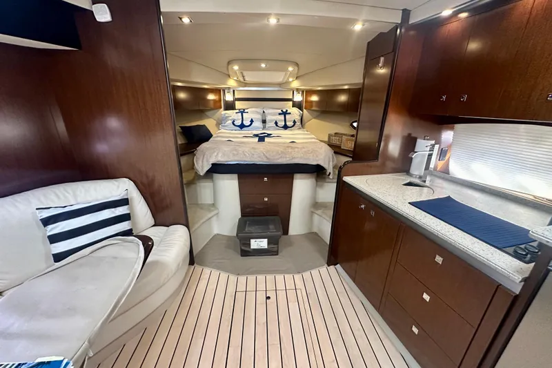  Yacht Photos Pics Luxurious interior of 2011 Cruisers Yachts 420 Sports Coupe with cozy bed and modern kitchenette.