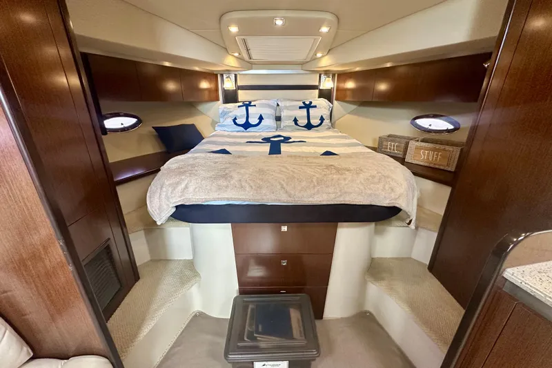  Yacht Photos Pics Luxurious 2011 Cruisers Yachts 420 Sports Coupe cabin with nautical-themed bedding.
