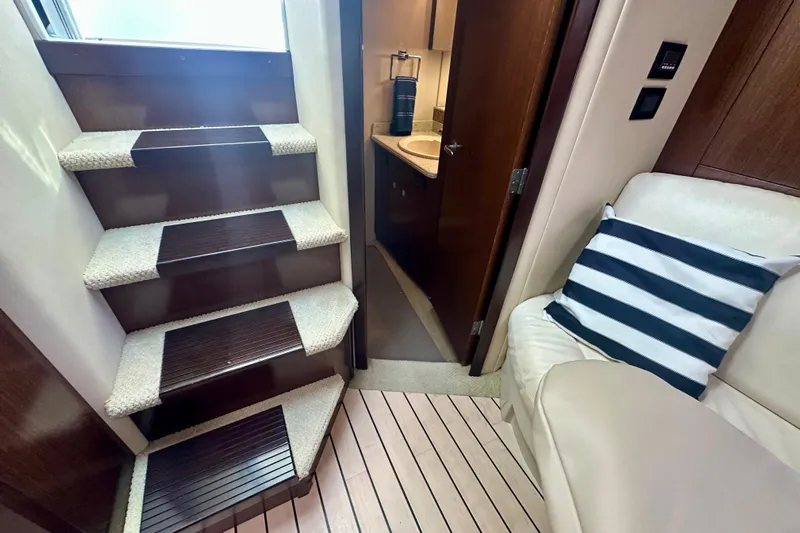  Yacht Photos Pics Interior of 2011 Cruisers Yachts 420 Sports Coupe, featuring stairs, seating, and bathroom entrance.