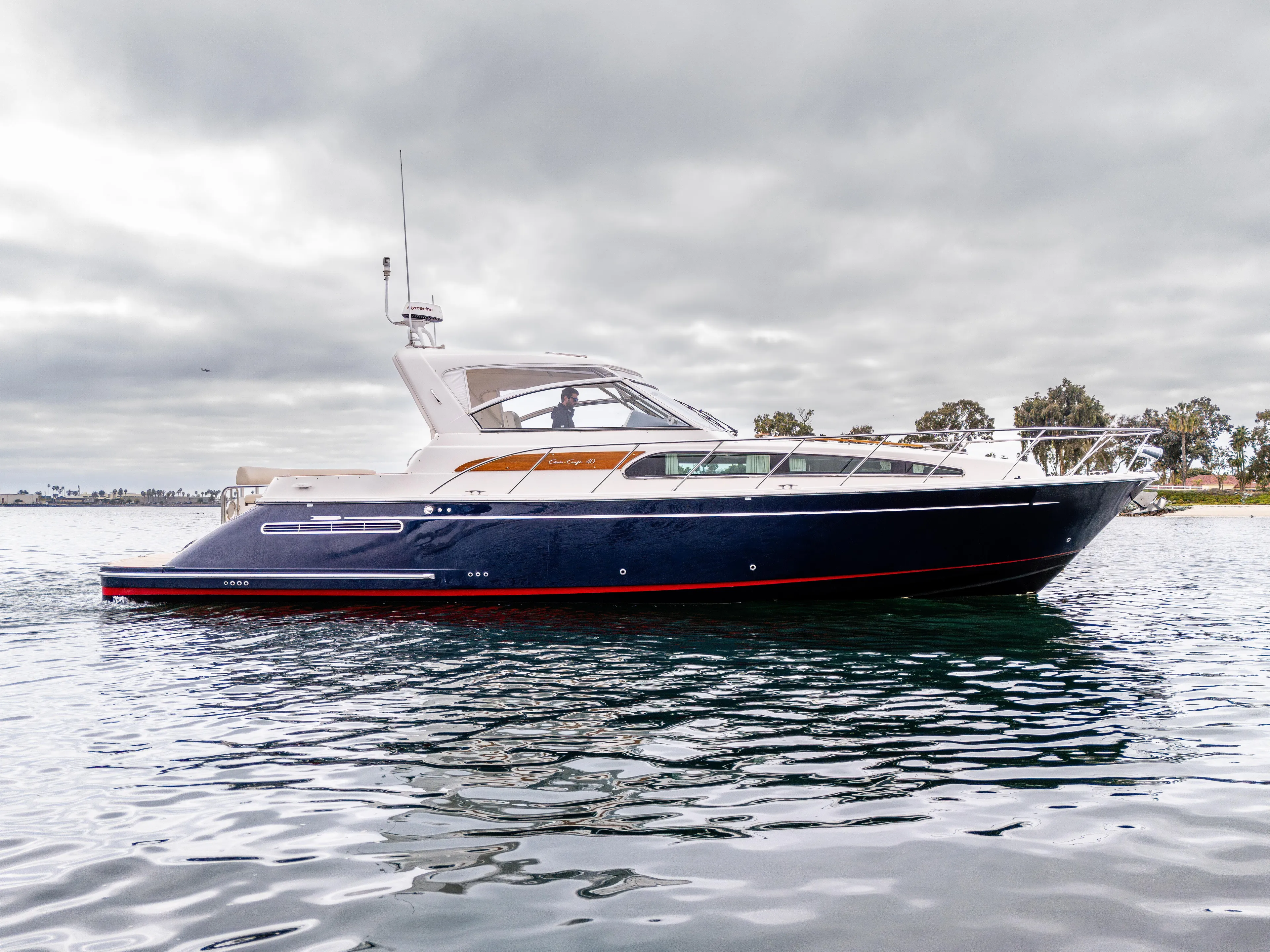 Zissou Yacht Photos Pics 2006 Chris-Craft Roamer 40 yacht on calm water under cloudy skies.