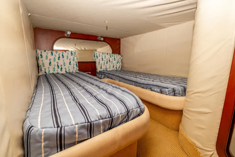 Zissou Yacht Photos Pics Interior cabin of 2006 Chris-Craft Roamer 40 with twin beds and striped bedding.