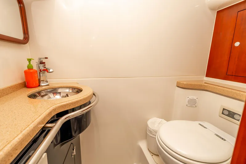 Zissou Yacht Photos Pics Luxurious bathroom in 2006 Chris-Craft Roamer 40 yacht with modern fixtures and wood accents.