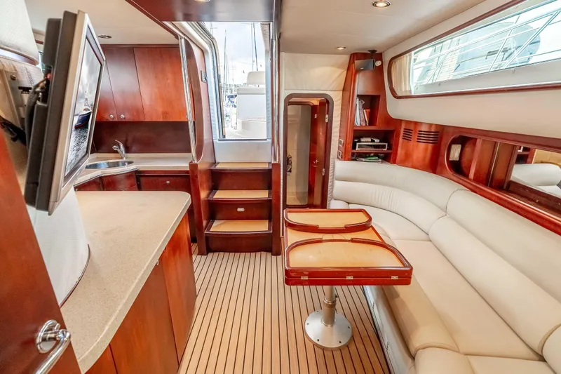 Zissou Yacht Photos Pics Luxurious interior of 2006 Chris-Craft Roamer 40 yacht with elegant wood finishes and plush seating.