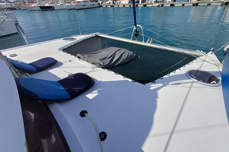  Yacht Photos Pics 2007 Fountaine Pajot Mahe 36 catamaran deck with seating and netting at marina.