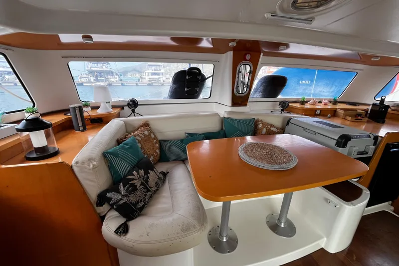  Yacht Photos Pics Interior of 2007 Fountaine Pajot Mahe 36 catamaran with cozy seating and dining area.