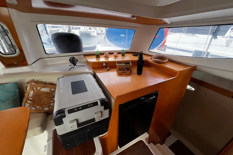  Yacht Photos Pics Interior of 2007 Fountaine Pajot Mahe 36 catamaran with kitchenette and seating area.