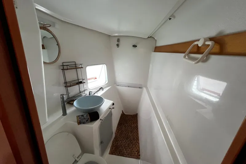  Yacht Photos Pics Bathroom interior of 2007 Fountaine Pajot Mahe 36 catamaran, featuring modern sink and window.