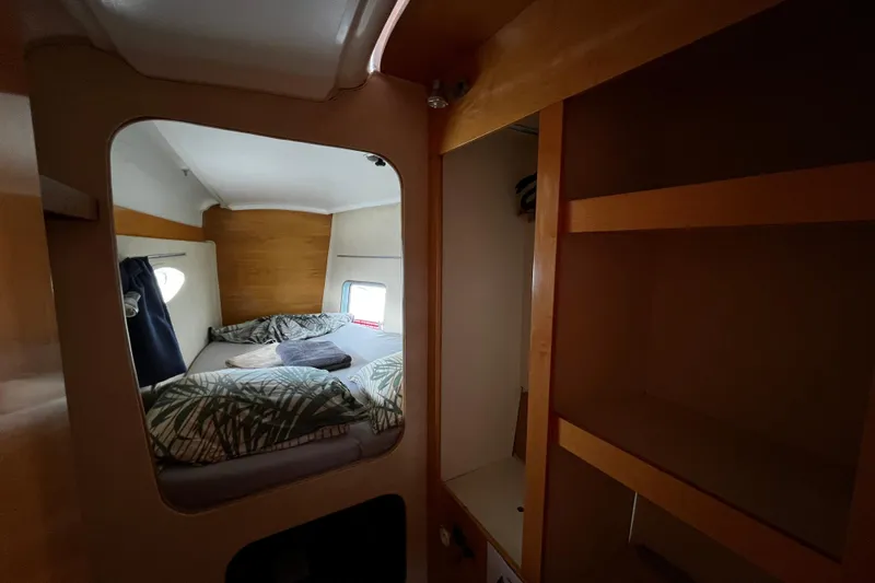  Yacht Photos Pics Cozy cabin interior of 2007 Fountaine Pajot Mahe 36 catamaran with bed and storage.