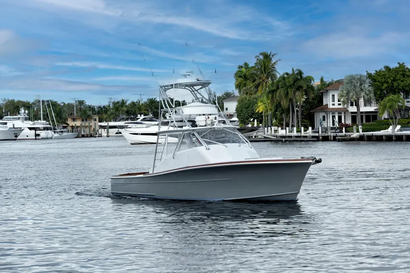 "double Down" Yacht Photos Pics 2014 Release Walkaround boat cruising in a scenic marina with palm trees and yachts.