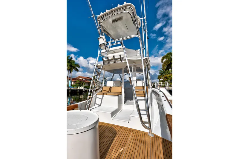 "double Down" Yacht Photos Pics 2014 Release Walkaround boat with tower and seating, docked under a clear blue sky.