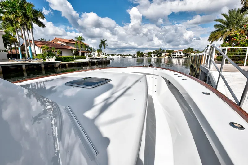 "double Down" Yacht Photos Pics 2014 Release Walkaround boat docked by waterfront homes under a cloudy sky.